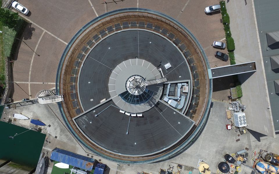 A top-down aerial view of a circular building and its surroundings